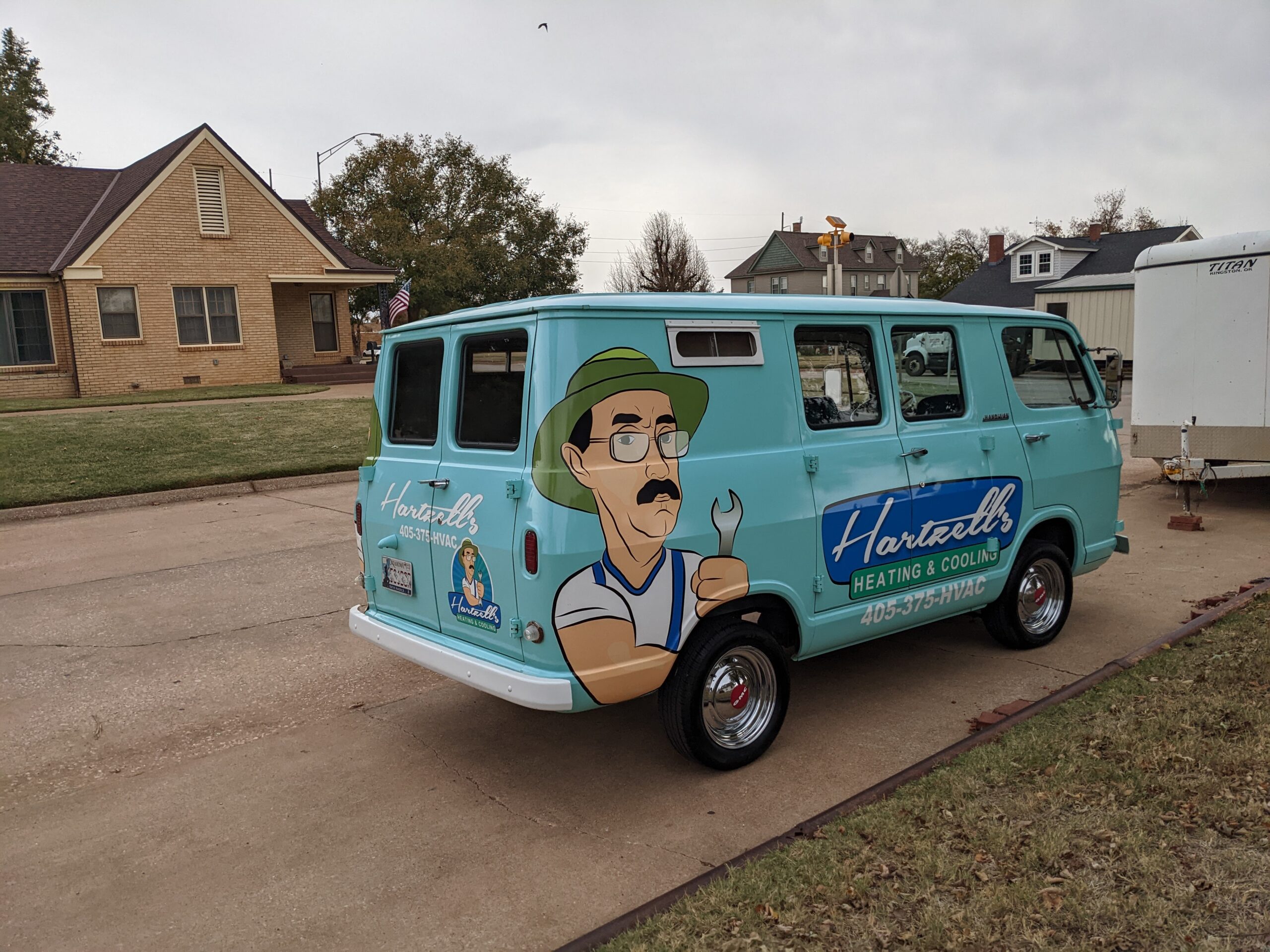 Hartzell's restored 1964 GMC van with teal paint and cartoon mascot wrap