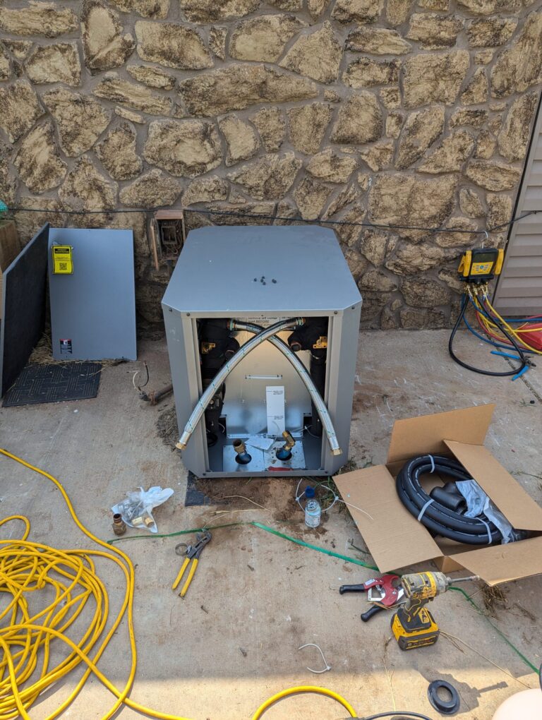ClimateMaster geothermal unit open during installation showing internal components