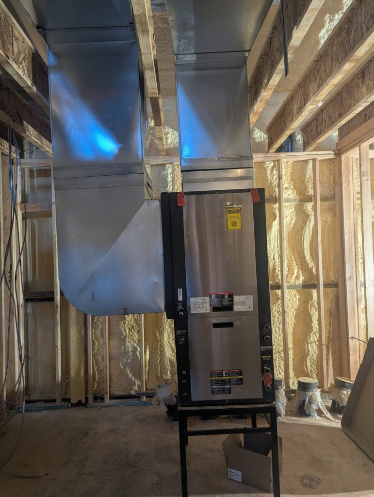 ClimateMaster geothermal heat pump unit installed in new construction home in Oklahoma with custom sheet metal ductwork