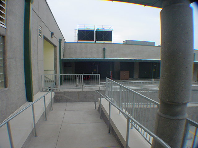 Completed cooling towers on rooftop of classified national infrastructure facility viewed from courtyard