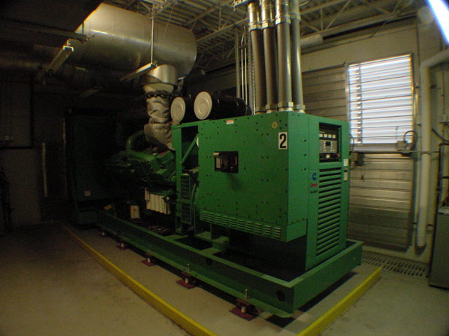 Cummins Generator 2 with twin stainless exhaust stacks on containment pad at commercial data center