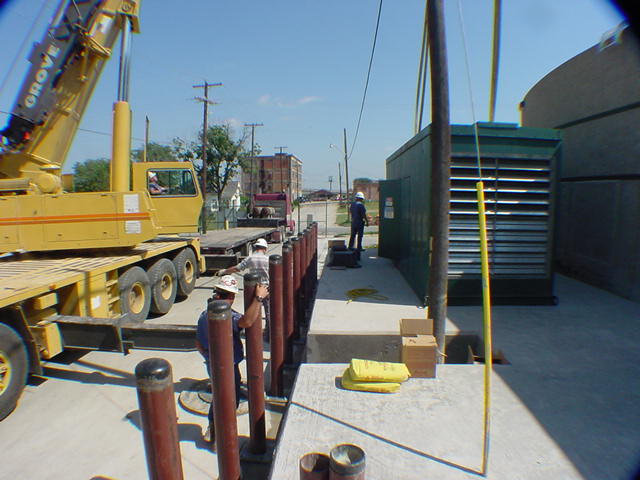 Cummins generator set installed on concrete pad at secured data center with Grove crane on site