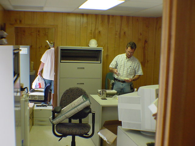 Dave Hartzell reviewing project documents and blueprints in Sprint infrastructure field office