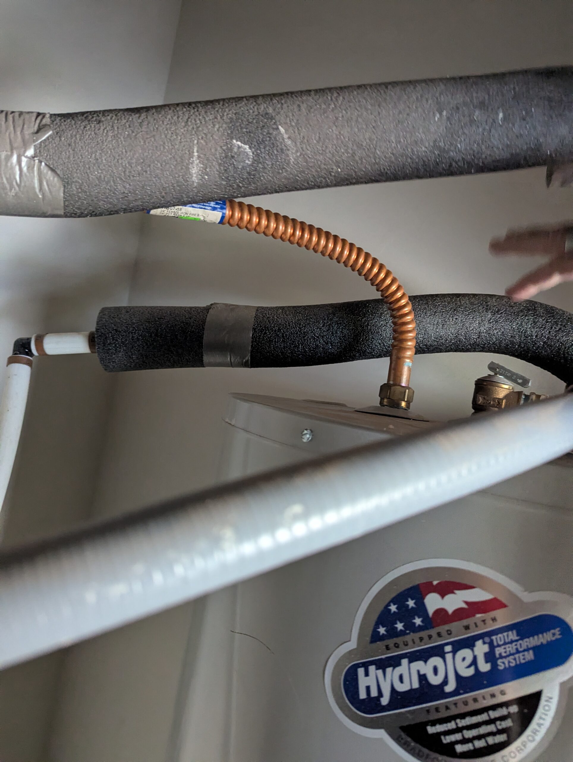 Geothermal desuperheater copper coil connection to water heater for free hot water Oklahoma