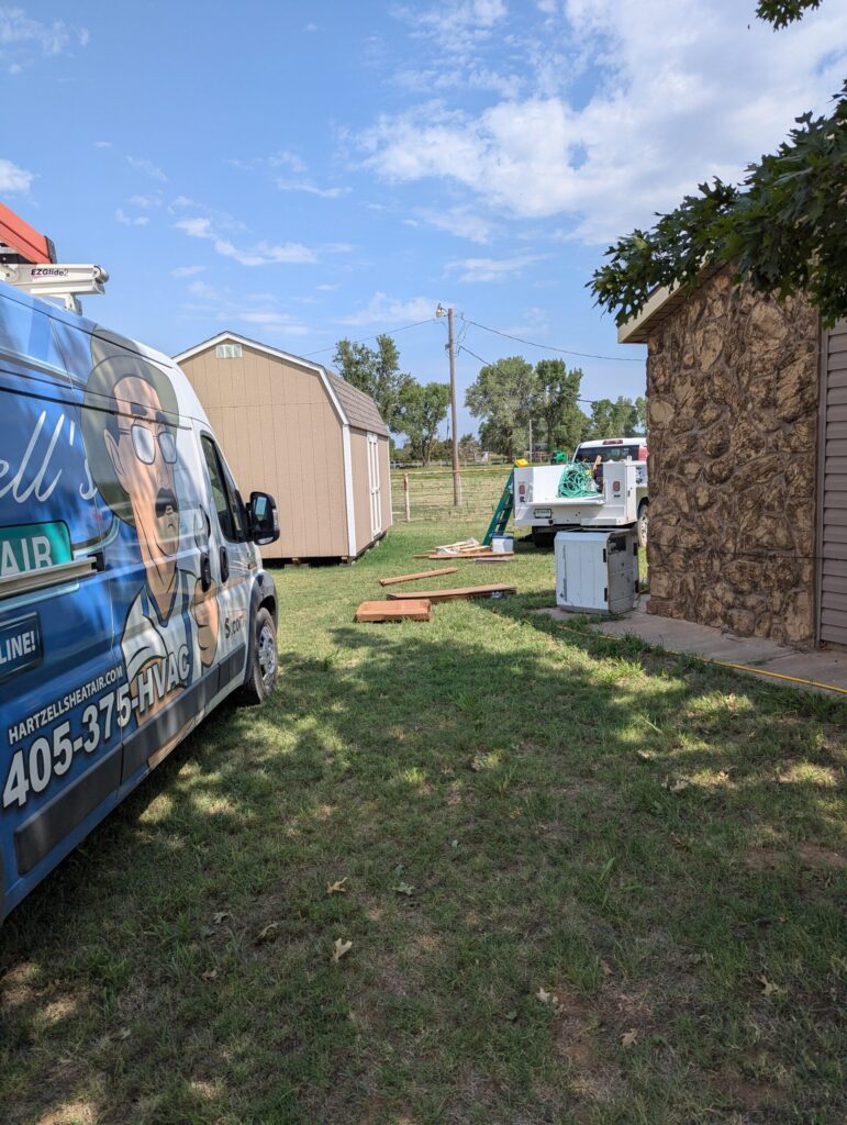 Hartzell's Heat & Air van and service truck at geothermal system installation job site in Oklahoma