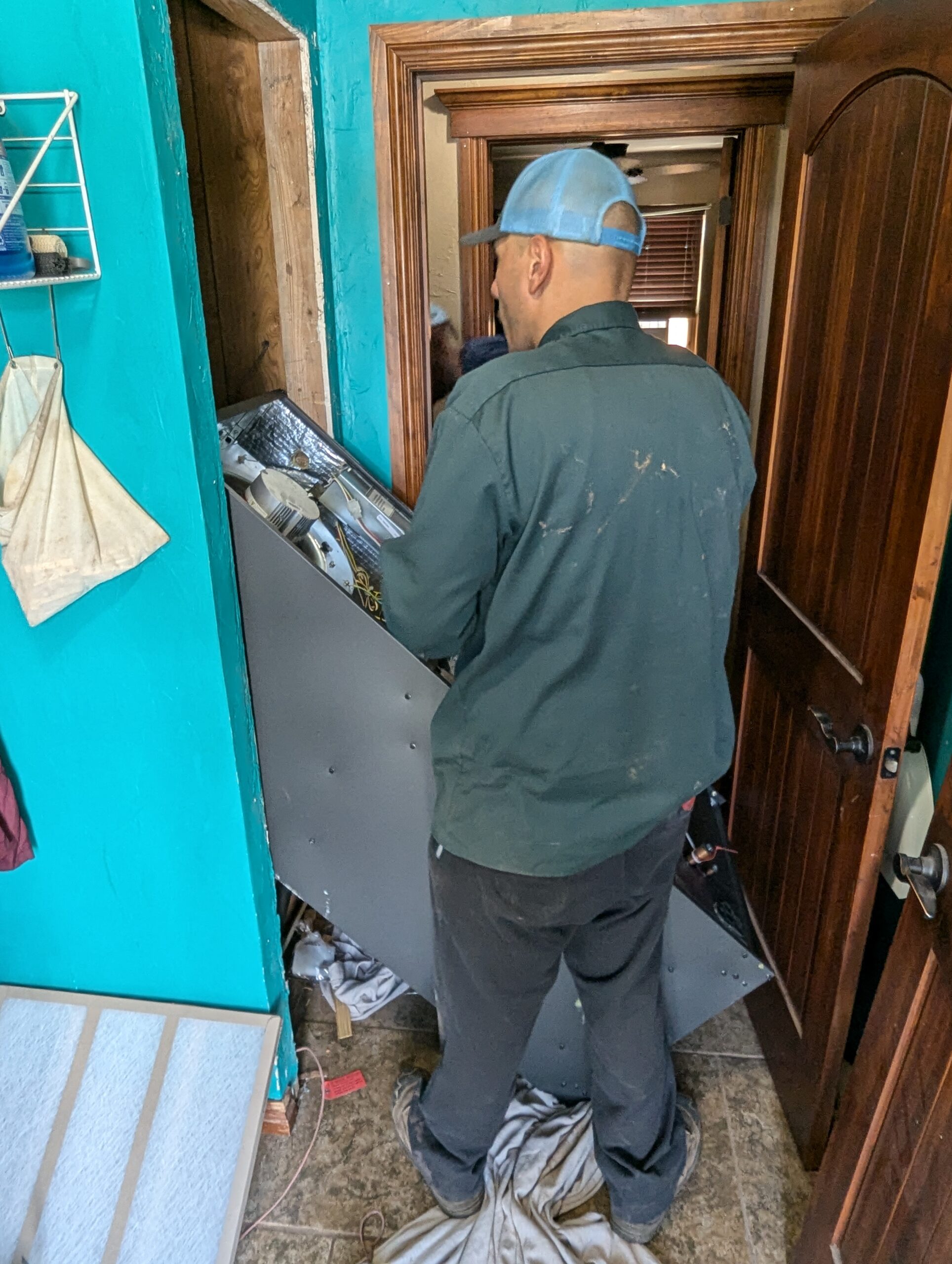 Hartzell's technician installing HVAC air handler blower section central Oklahoma