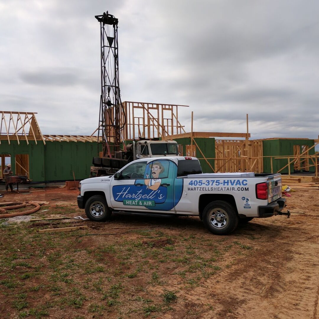 Hartzell's Heat & Air truck at geothermal drill rig new construction Oklahoma