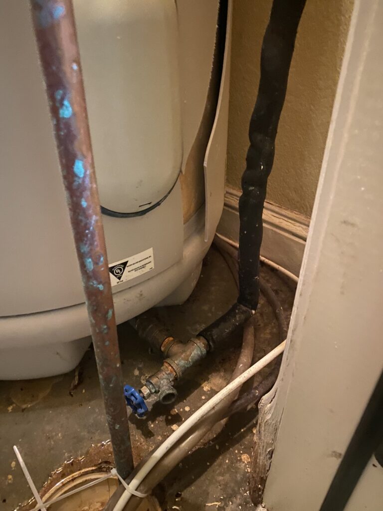 Corroded water heater pipes and fittings before replacement