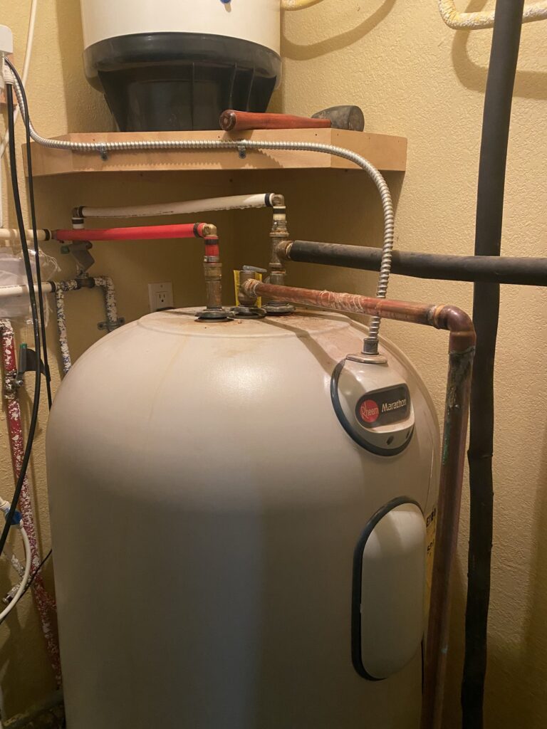 Existing Rheem Marathon water heater before replacement