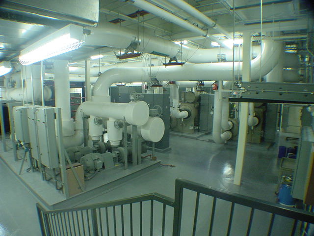 Completed chilled water plant with centrifugal chillers and white insulated pipe headers at Sprint facility