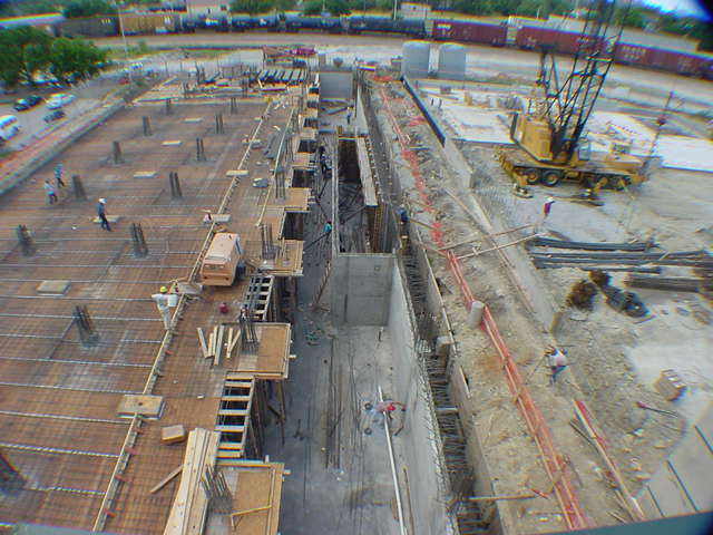 Aerial view of Sprint infrastructure construction site with crane and concrete foundation work in progress