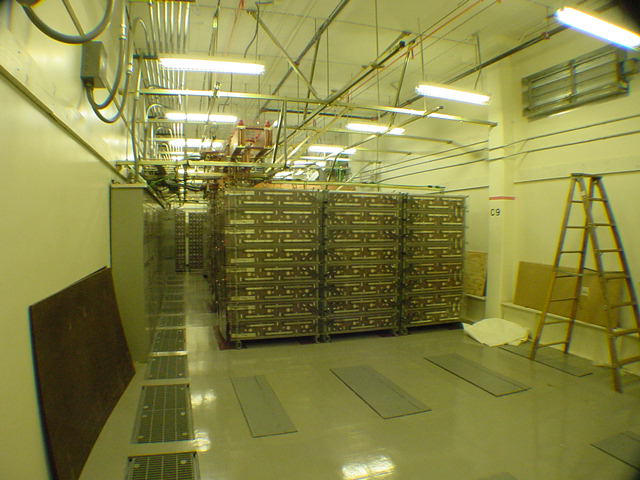 Telecom data center 20000 amp battery backup room with rows of battery strings raised floor and cable tray