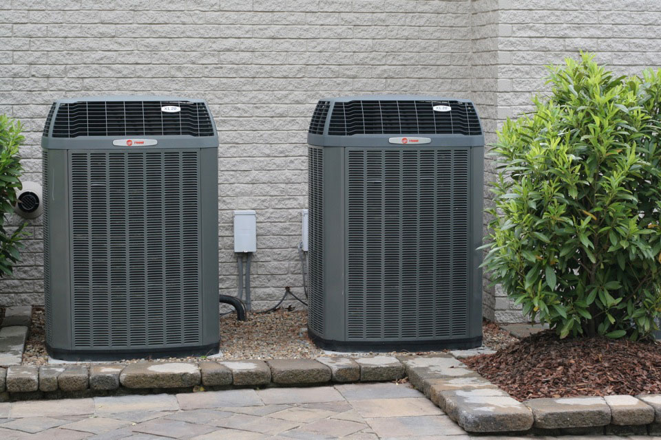 Trane heat pump outdoor condenser units installed at Oklahoma home — properly charged and running