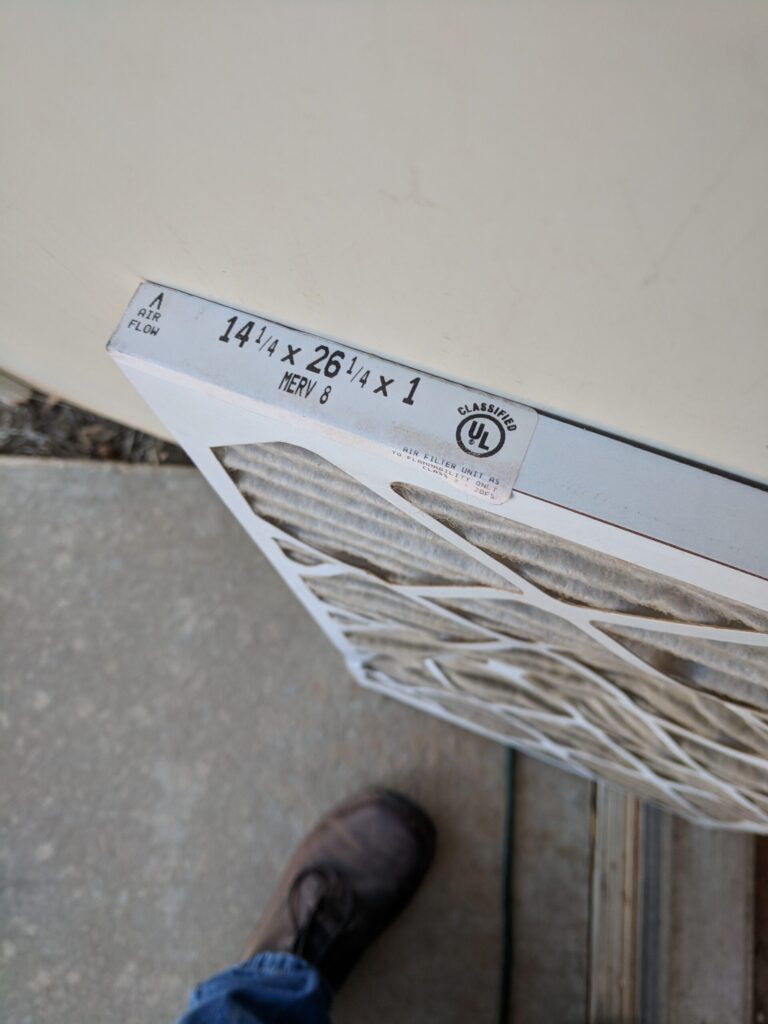 MERV 8 air filter being replaced in a residential HVAC return