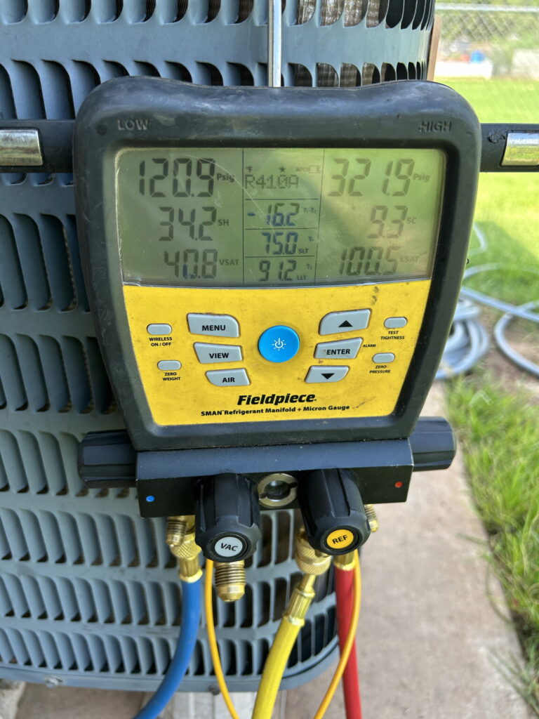 Fieldpiece SMAN manifold gauge connected to an air conditioner during an HVAC diagnostic in Oklahoma