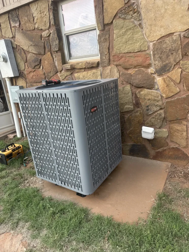 RunTru by Trane outdoor unit at a stone home in Kingfisher
