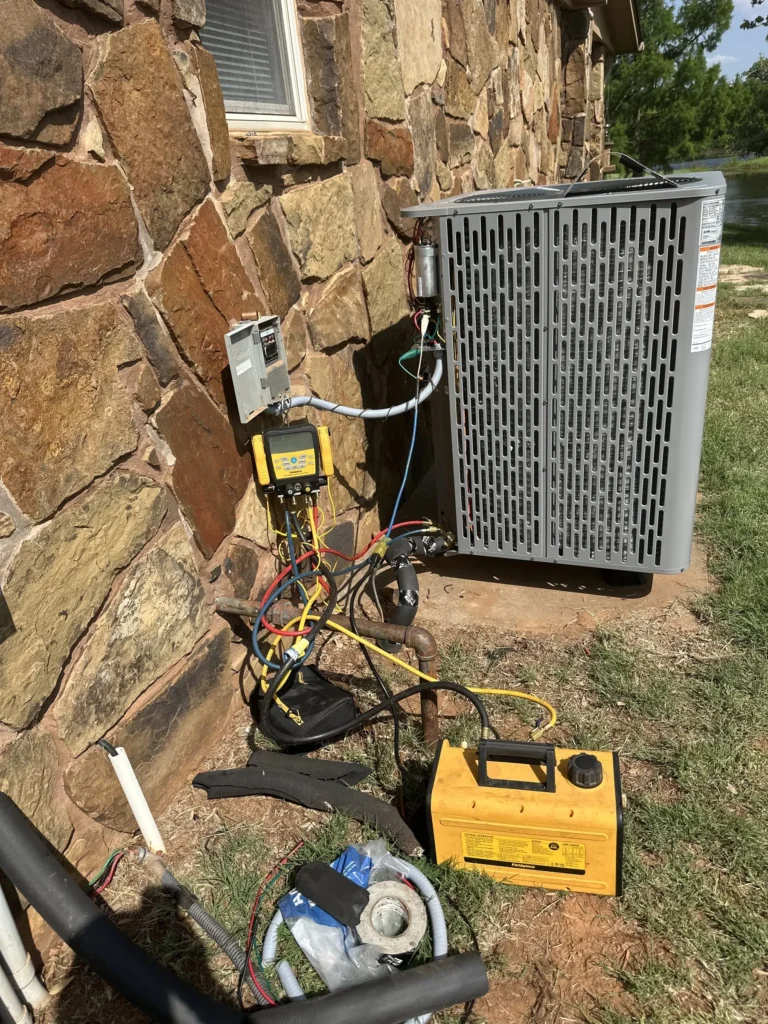 Trane condenser being commissioned with refrigerant gauges