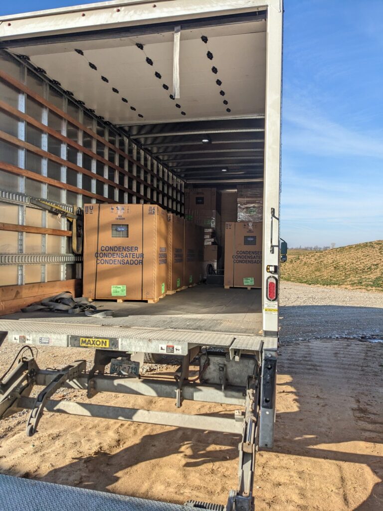 Carrier commercial condensing units being delivered on a box truck for the new HVAC system at The Cedar Gate event venue near Loyal, Oklahoma, installed by Hartzell's Heat and Air