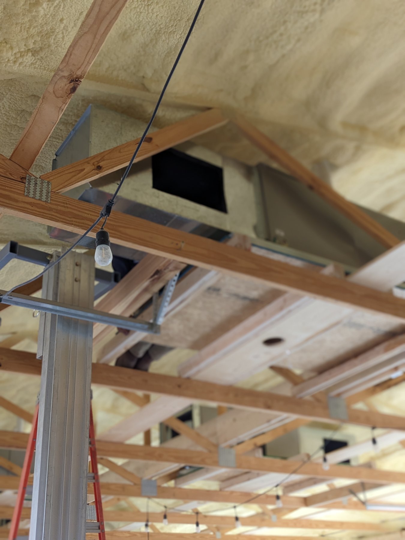 Commercial air handler and ductwork hung between the wood trusses at The Cedar Gate event venue near Loyal, Oklahoma during a Hartzell's Heat and Air dual-fuel HVAC installation