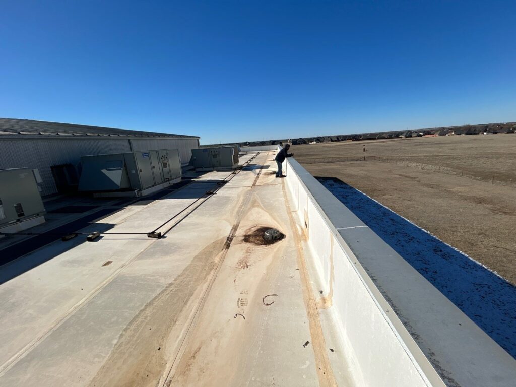 Hartzell's technician inspecting commercial rooftop HVAC units in Oklahoma