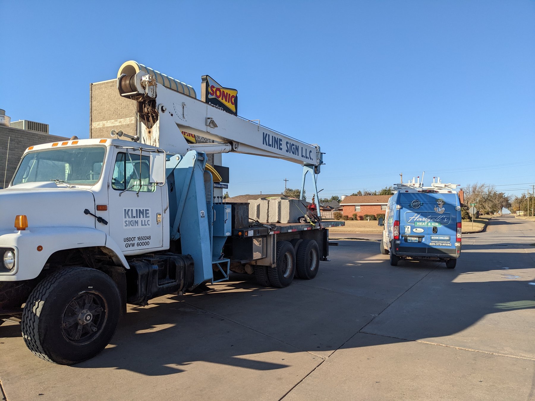 Hartzell's Heat and Air van and crane truck at the Sonic in Kingfisher, Oklahoma for a commercial packaged rooftop unit replacement