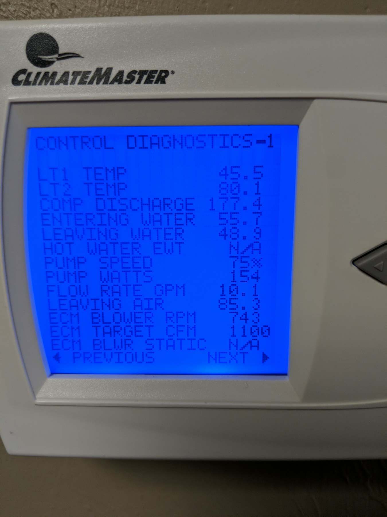 ClimateMaster geothermal control diagnostics screen reading entering water and leaving water temperatures and loop flow rate in gallons per minute on a commercial water-source heat pump at the Wheeler Brothers operation in Watonga, Oklahoma