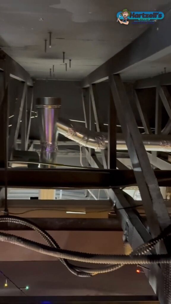 New duct and roof vent pipe up in the steel joists of an Okl
