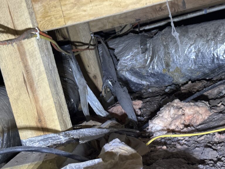 Old flex duct fallen off its hangers onto the dirt in a crawlspace in Okarche, Oklahoma