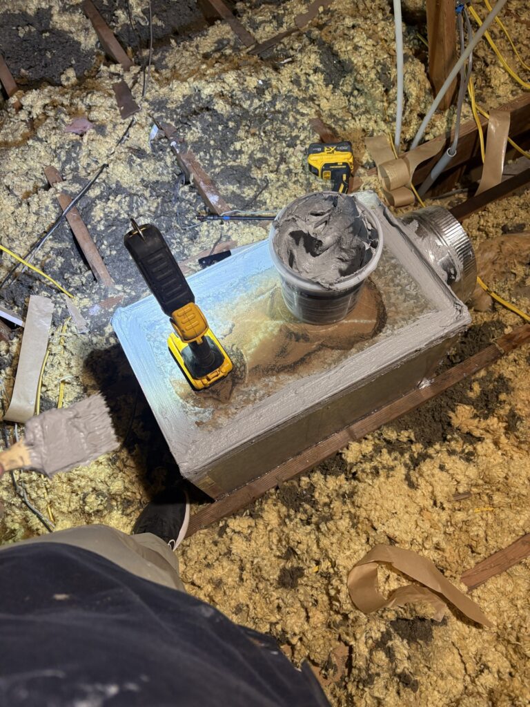 Mastic brushed onto a sheet metal supply boot in an attic in Kingfisher, Oklahoma