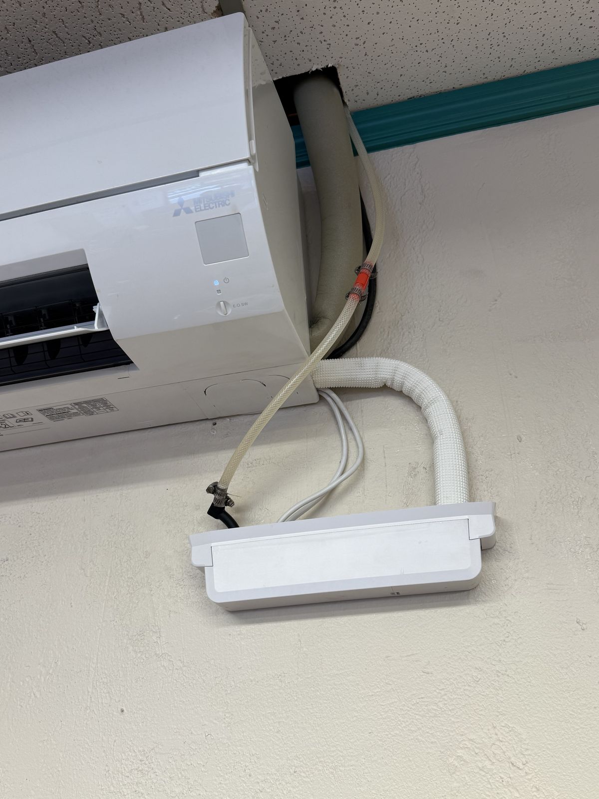 Ductless mini-split indoor unit with its condensate pump, mini-split warranty repair in Edmond, OK