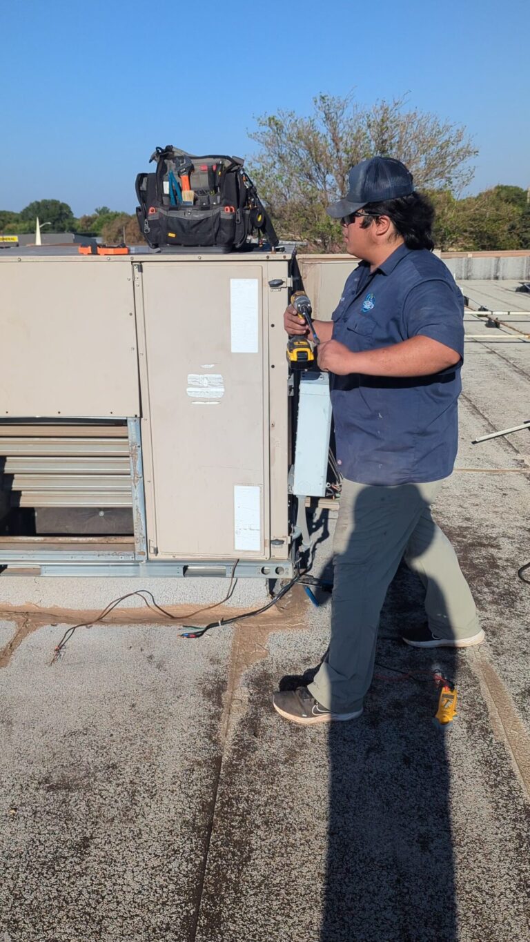 Technician wiring the disconnect on a new commercial rooftop unit